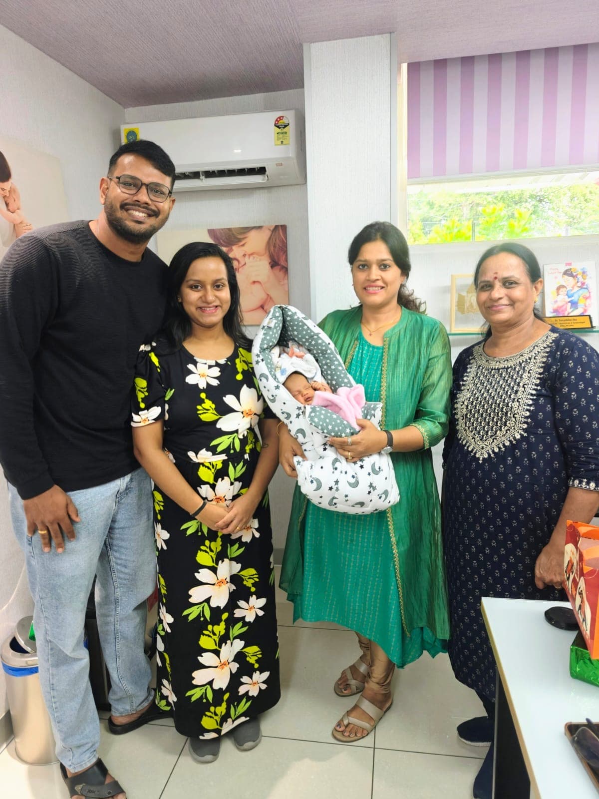 Family gathered with Dr. Deepshika Jha in a warm clinic moment