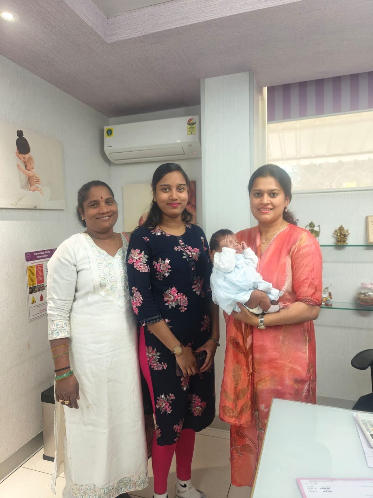 Parents and their baby with Dr. Deepshika Jha after a visit