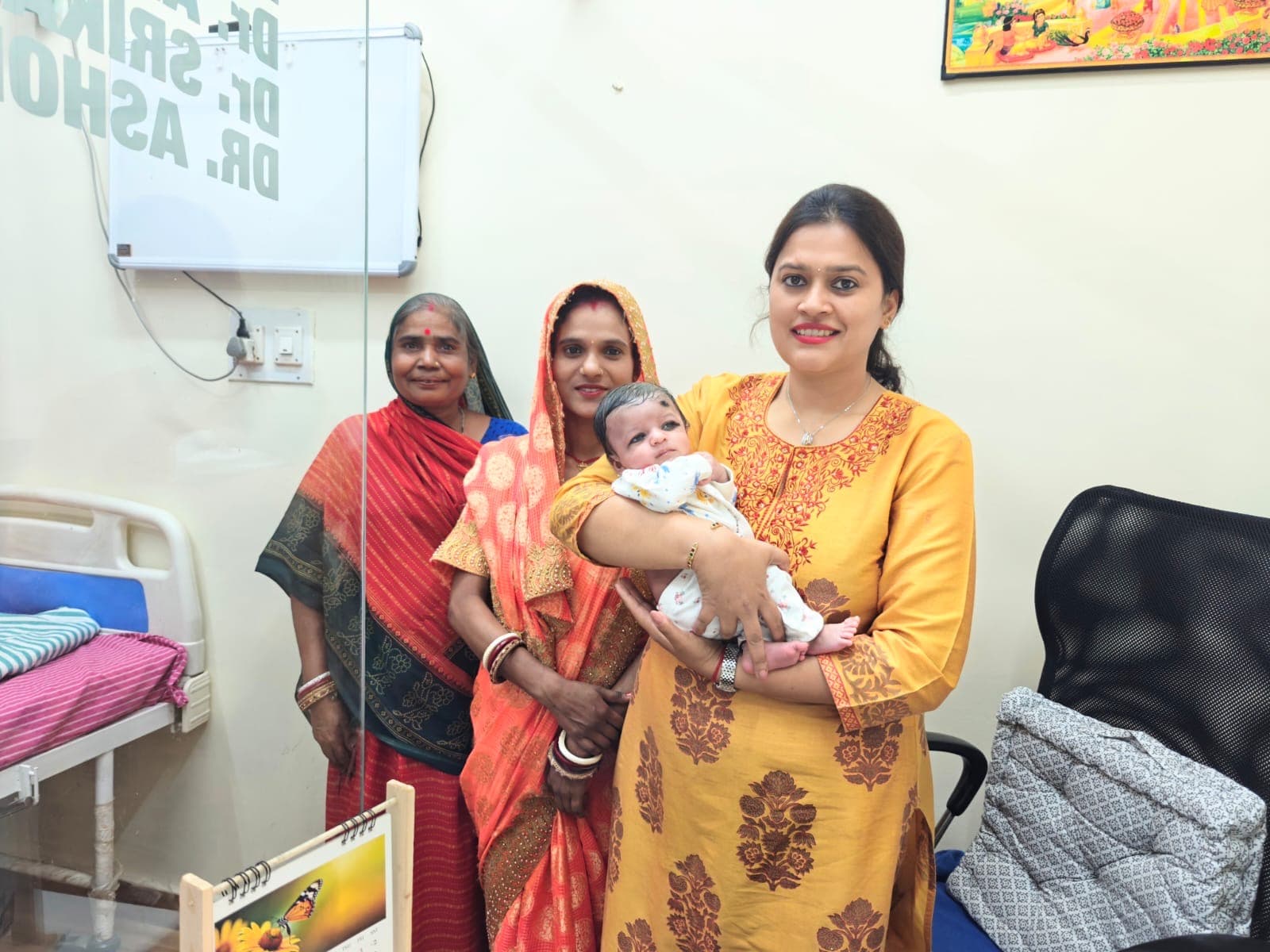Dr. Deepshika Jha with a mother and newborn in a caring postpartum moment