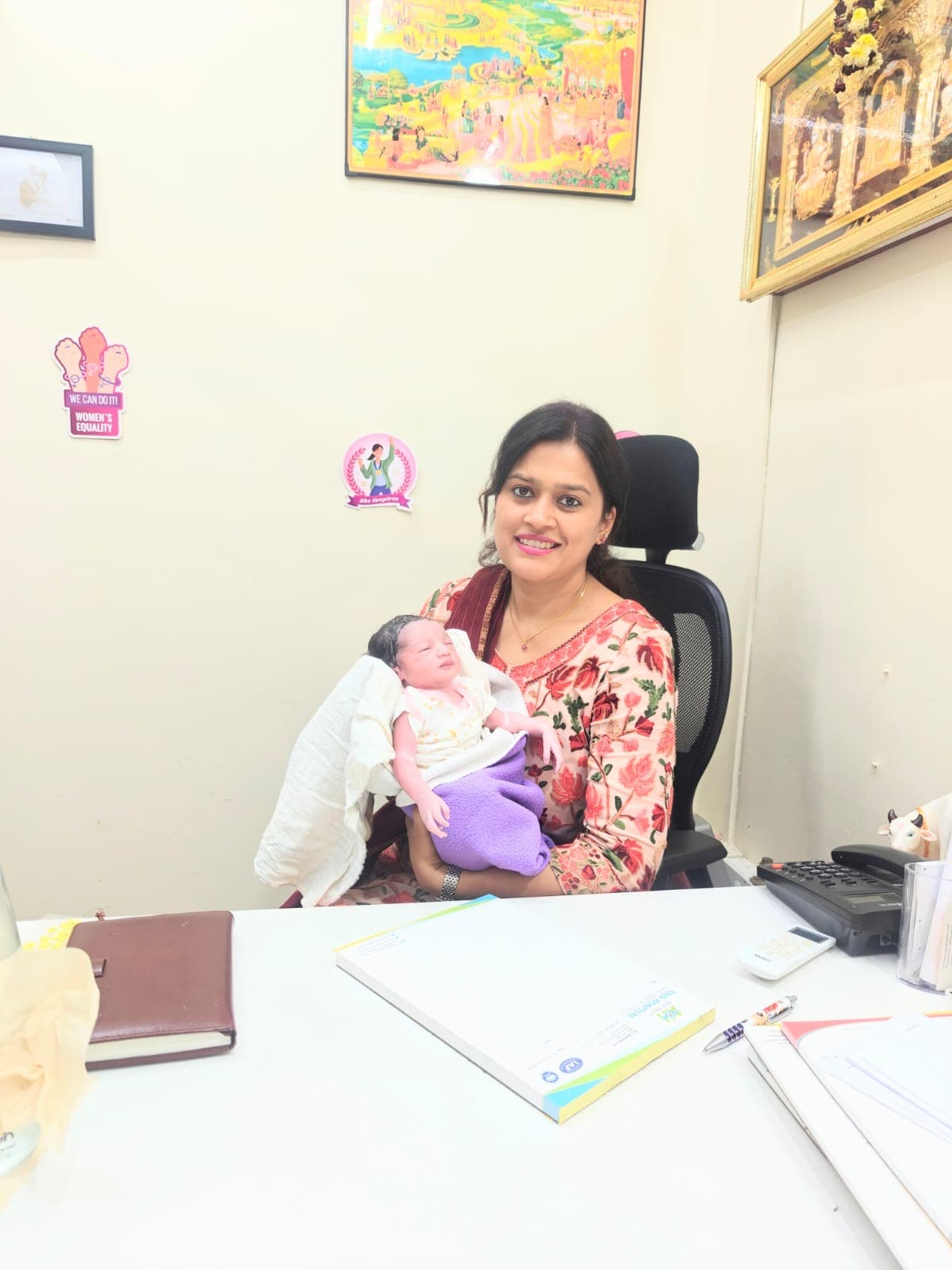 Dr. Deepshika Jha with a newborn baby in a care setting