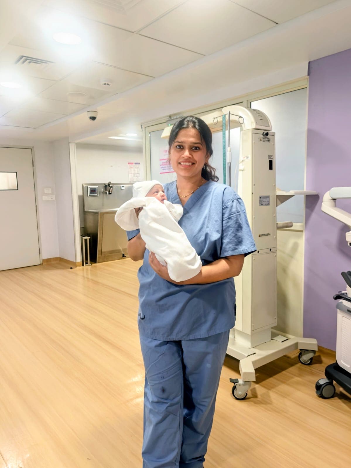Dr. Deepshika Jha with a newborn during a postpartum care moment